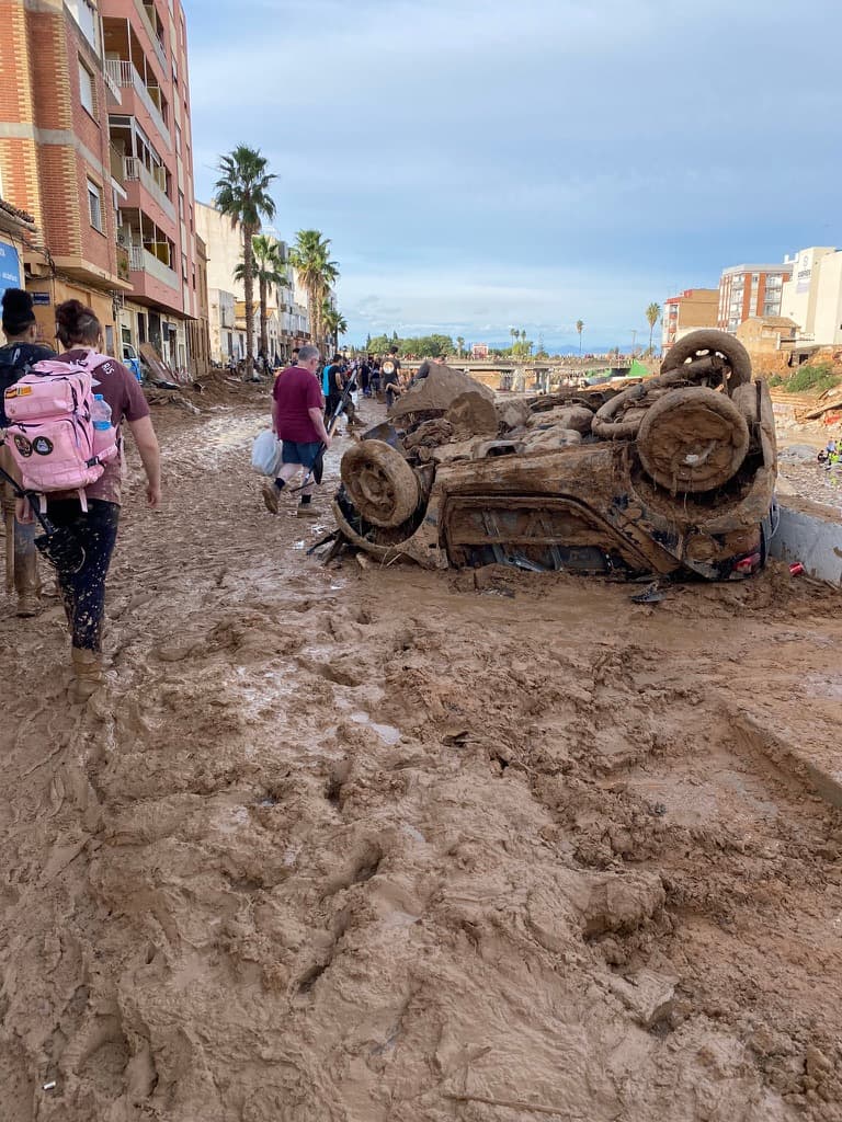 Car flipped upside down due to flood damage in Valencia